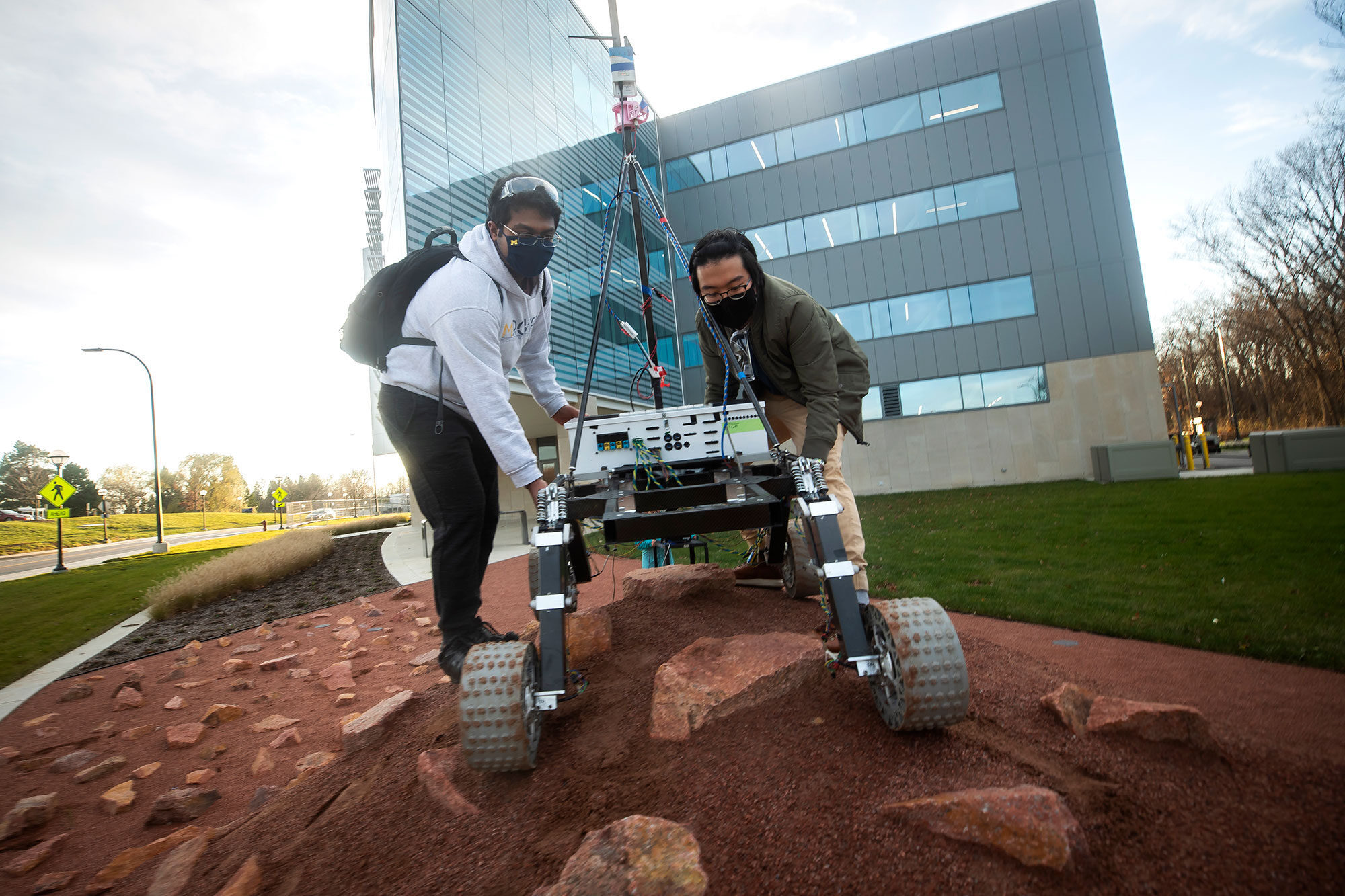 Members of the Michigan Mars Rover team test out a rover on the Mars Yard outside of the Ford Motor Company Robotics Building on North Campus.