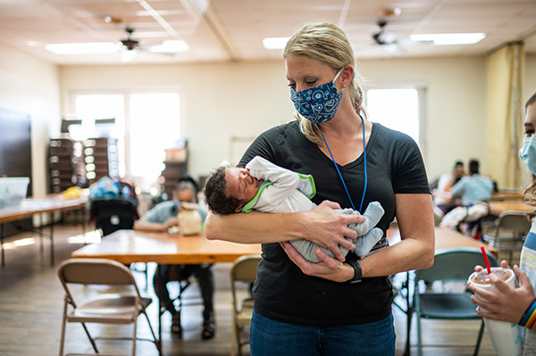 Photo of a caregiver holding an infant